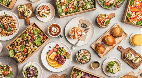 Flat lay of Soul Origin Catering options, including salads, sliders, wraps and fruit platters