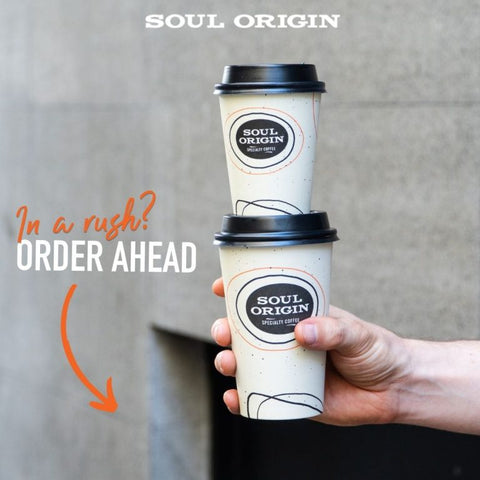 Hand holding two Soul Origin coffee cups